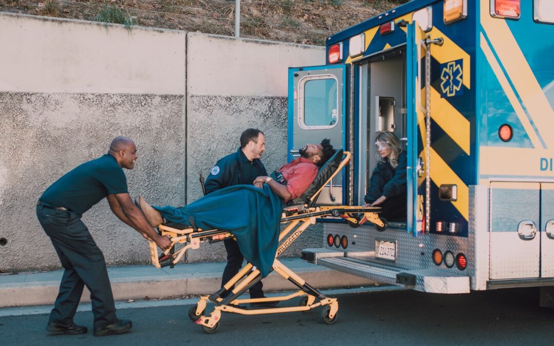 paramedics hurriedly ushered a man into an ambulance following a car collision