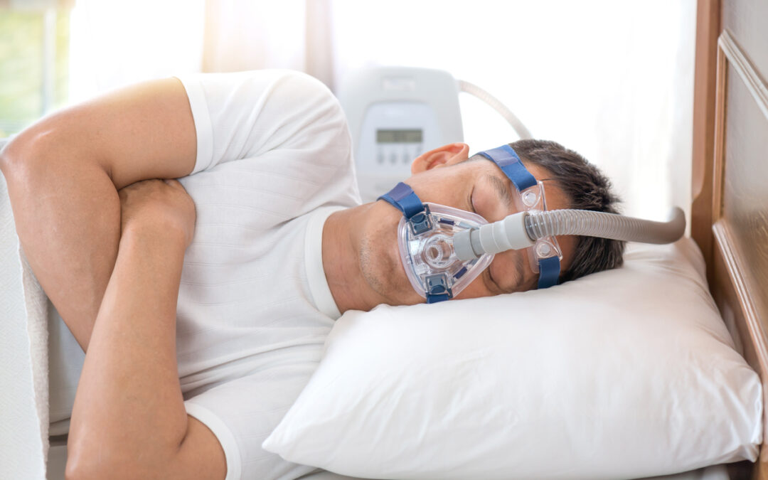 Man sleeping in bed wearing CPAP mask ,sleep apnea therapy